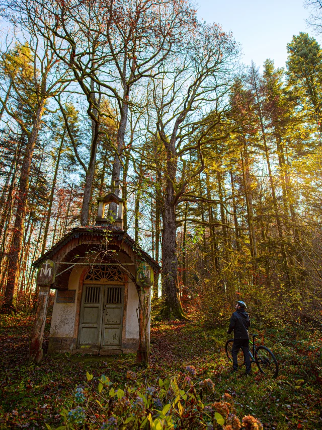 Un VTTiste arpente les forêts des Vosges du Sud, et s'arrête devant une chapelle au milieu des bois